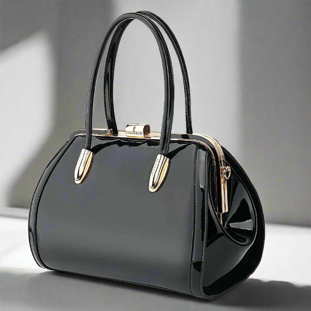 Classic patent leather handbag with a gemstone kiss lock clasp, available in ivory, emerald green, bronze, black, red, navy blue, and champagne pink, featuring top handles and a detachable strap for shoulder or crossbody wear